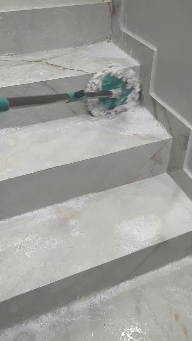 Apartment Deep Clean: 14 Areas to Scrub, Dust, and Vacuum 14 Scrubbing brush cleaning white marble stairs covered in soapy white cleaning foam.