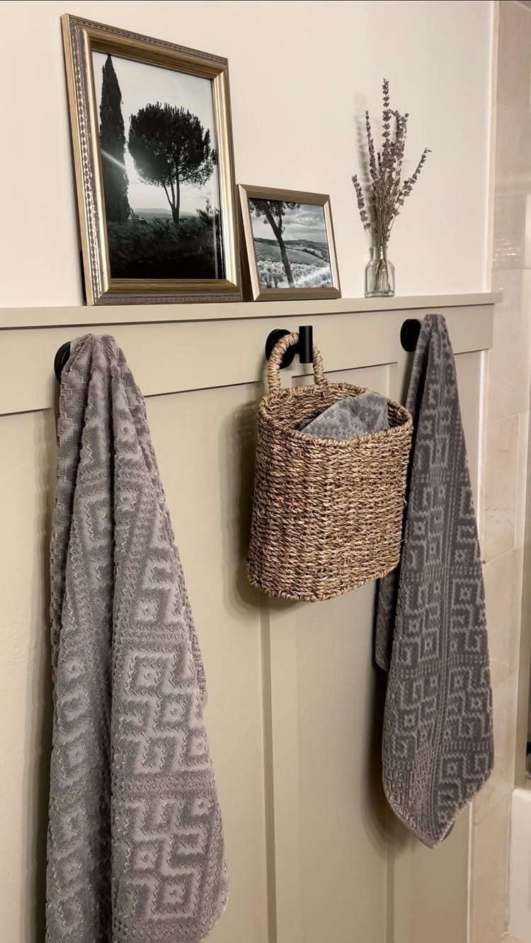 Board and Batten: 8 Styles That Update the Classic Wall Treatment 6 Beige board and batten wall with decorative shelf, hanging basket, and patterned grey towels.