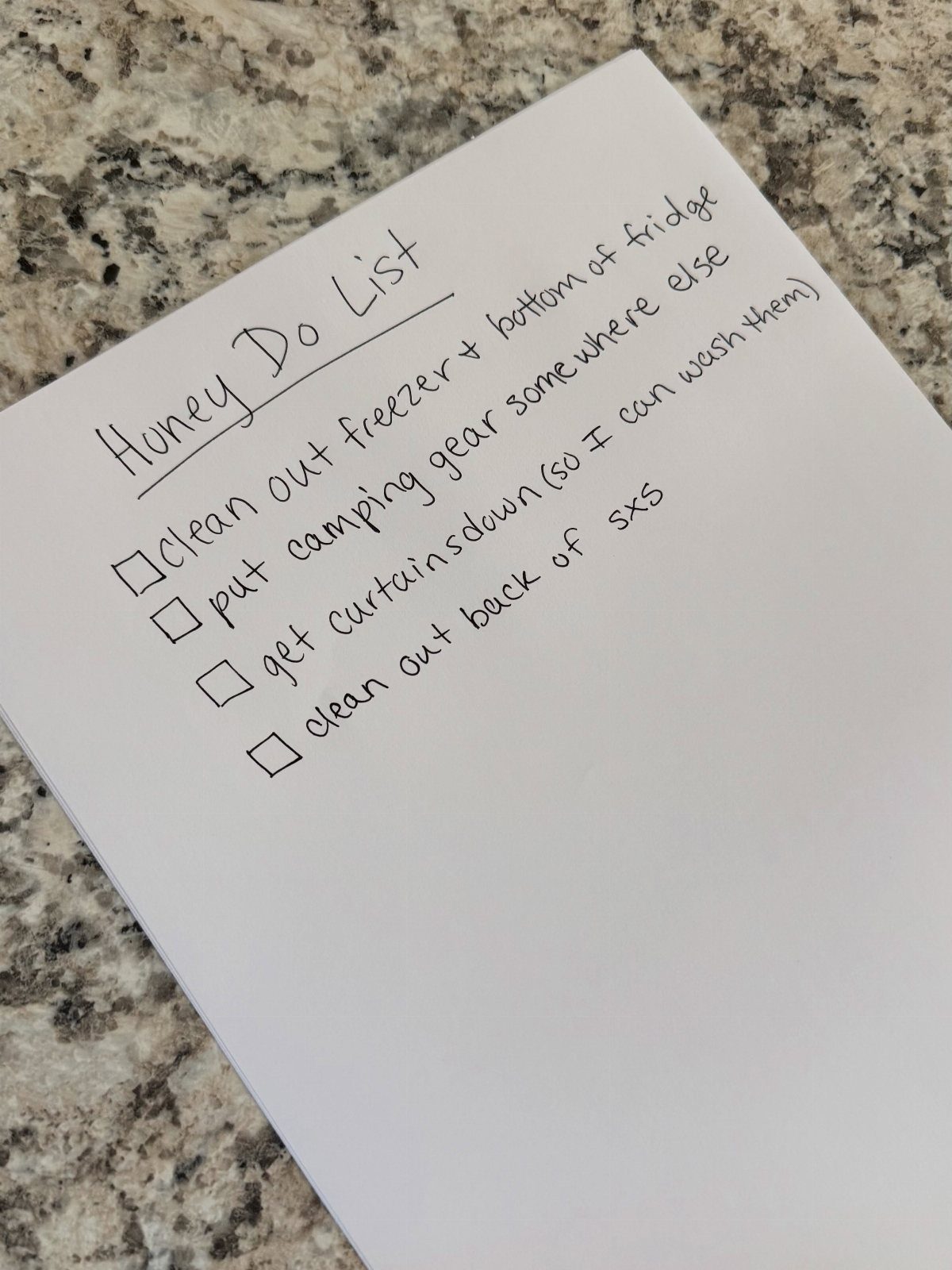 Chore List Ideas for the Family: 5 Charts and Lists to Use 5 Handwritten chore list on white paper resting on a granite kitchen countertop.