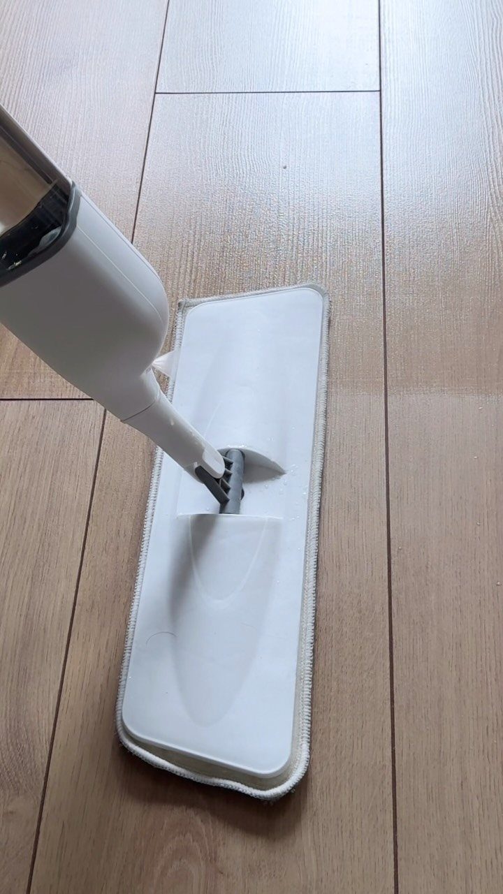 Chore List Ideas for the Family: 5 Charts and Lists to Use 2 White floor mop cleaning a light brown wooden plank floor.