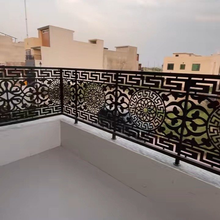 Fence Grill Design Modern: 28 Ideas from Steel to Aluminum 15 Black metal balcony railing with ornate circular patterns on a white balcony.