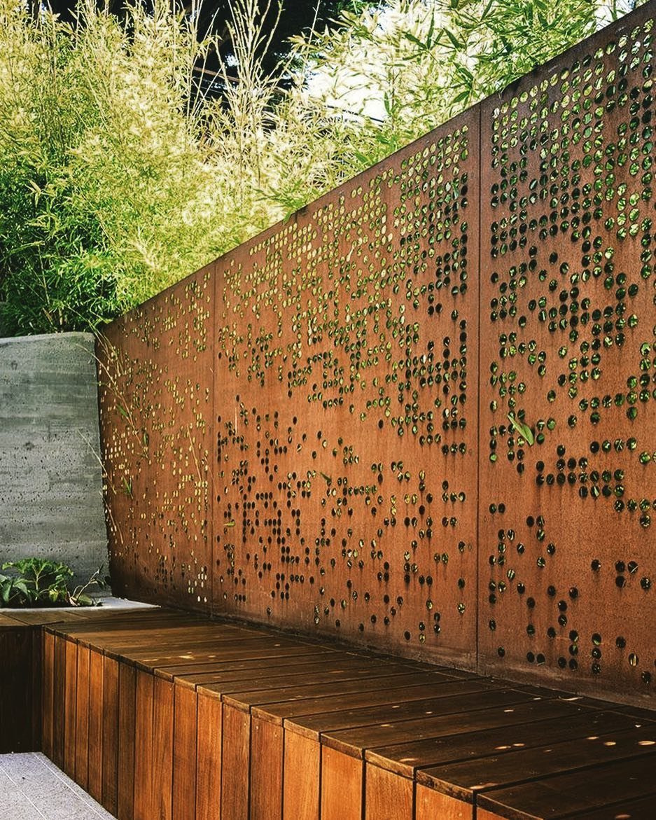 Fence Grill Design Modern: 28 Ideas from Steel to Aluminum 3 Rusted Corten steel fence panels with decorative perforations and a wooden bench.