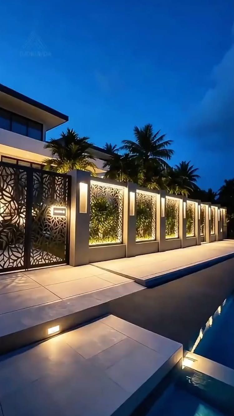 Fence Grill Design Modern: 28 Ideas from Steel to Aluminum 20 Modern black laser-cut metal fence grill with concrete pillars and warm evening lighting.