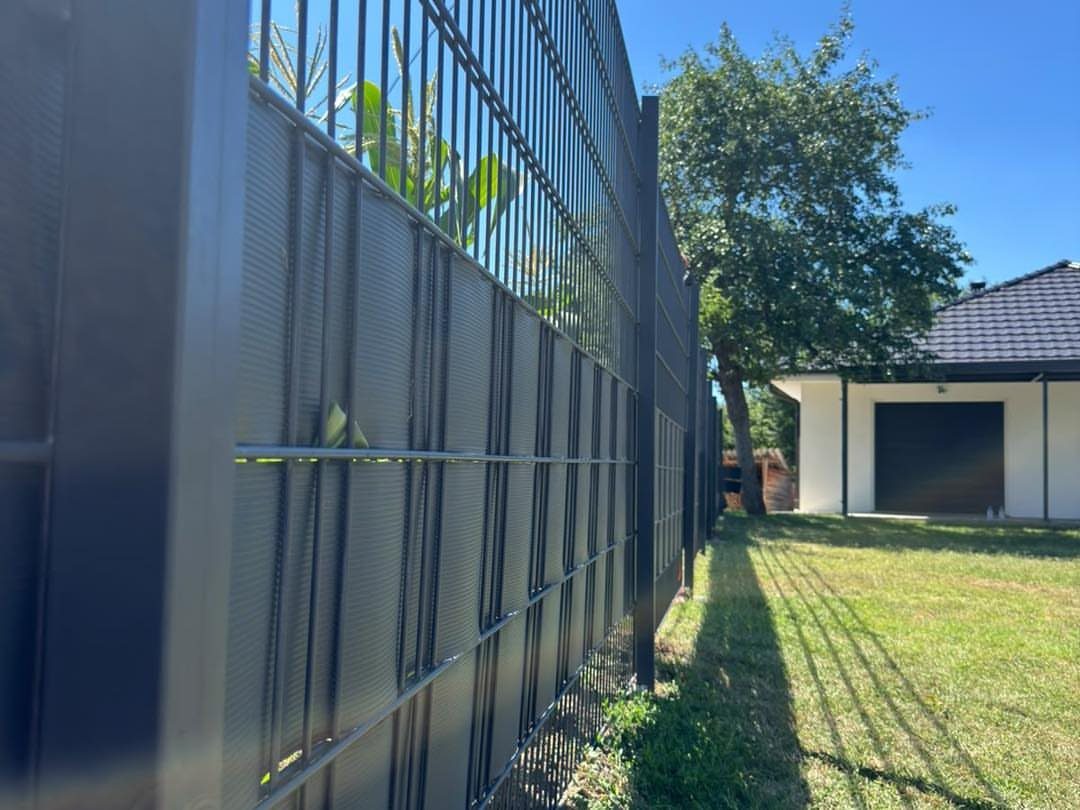 Fence Grill Design Modern: 28 Ideas from Steel to Aluminum 28 Black metal fence with privacy mesh installed in a green grassy yard