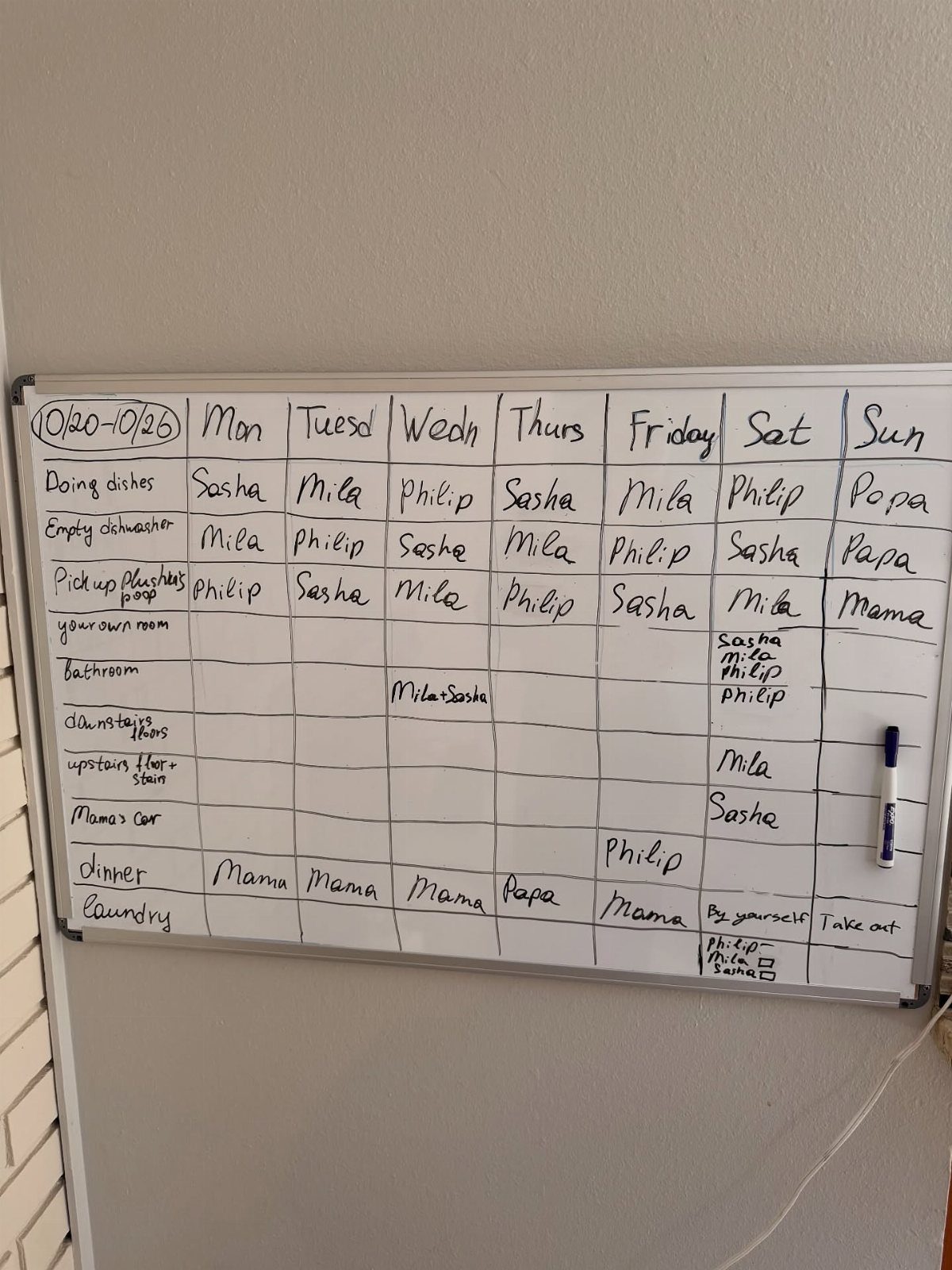 Free Chore List Templates: 3 Chore Charts for Kids and Adults 1 Handwritten weekly chore chart on a white dry-erase board with assigned names.