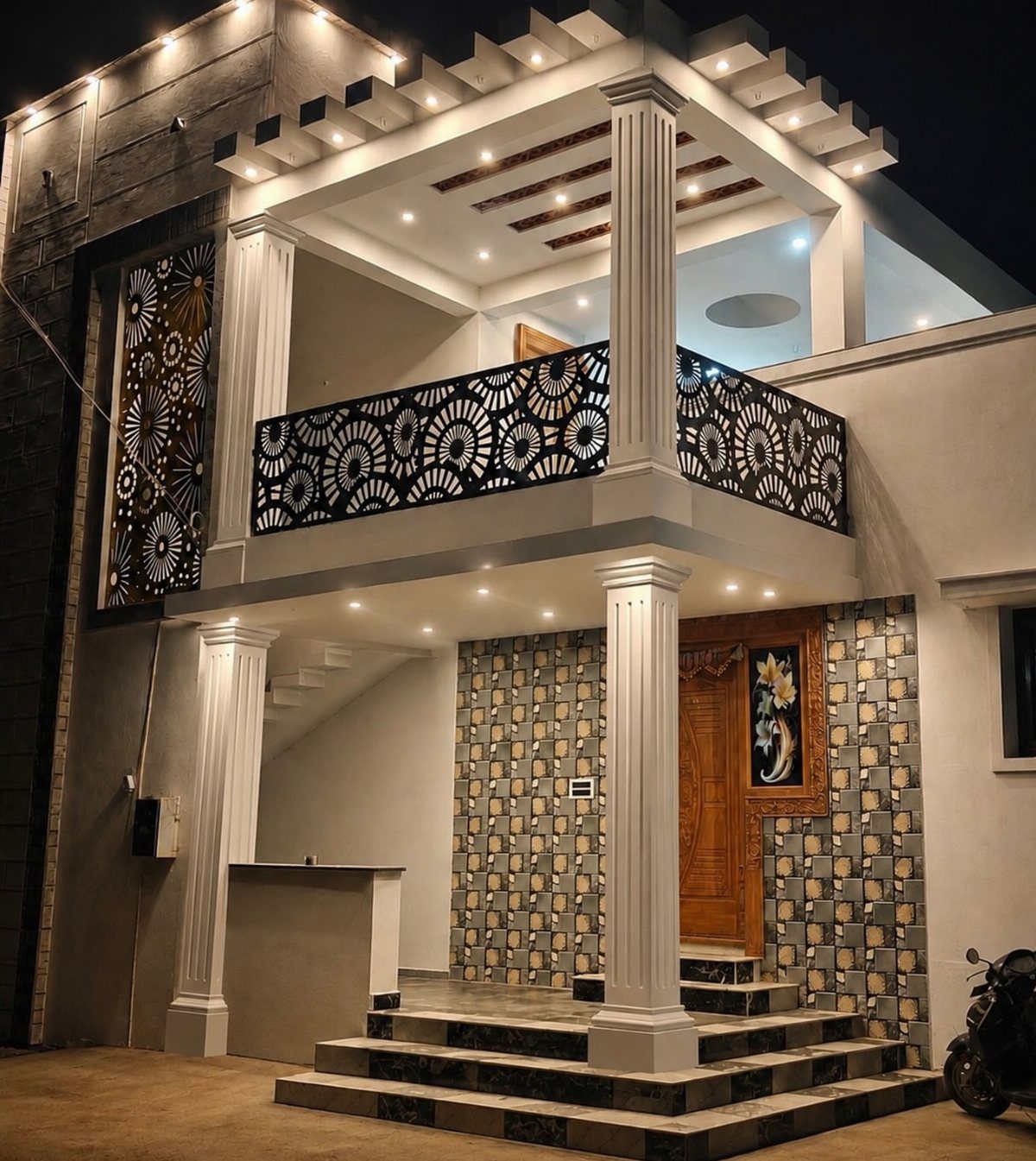Modern house exterior featuring black floral laser-cut metal grills on the balcony and walls.