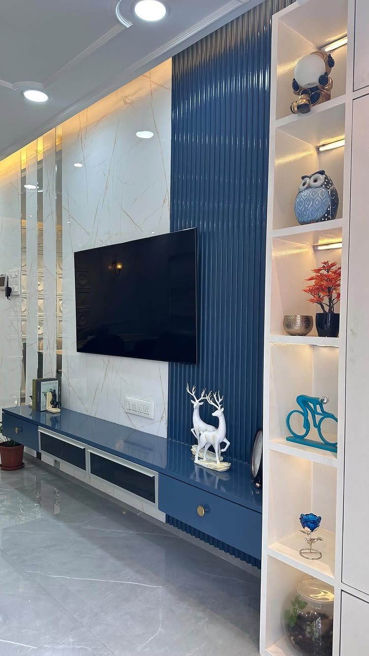 Interior Color Schemes: 9 Real Rooms That Make Them Work 6 Modern living room with a blue fluted accent wall, white marble panels, and a blue media console.