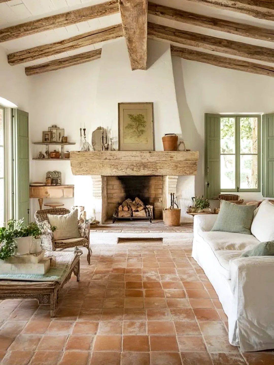 10 Modern Farmhouse Flooring Ideas for Every Room 9 Terracotta tiles cover the floor of a rustic living room with a stone fireplace.