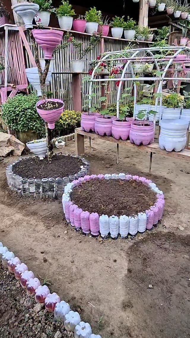 Painted Raised Garden Beds: 11 Ideas for Your Yard 10 Circular raised garden beds made from pink and white painted plastic bottles.
