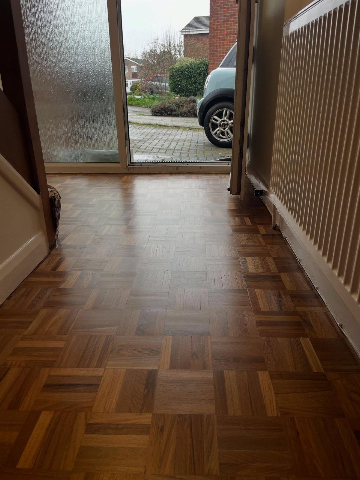 Parquet Floor Pattern: 8 Historic Layouts That Still Define Interiors 4 Wooden parquet floor with a mosaic pattern of small square blocks in a hallway.