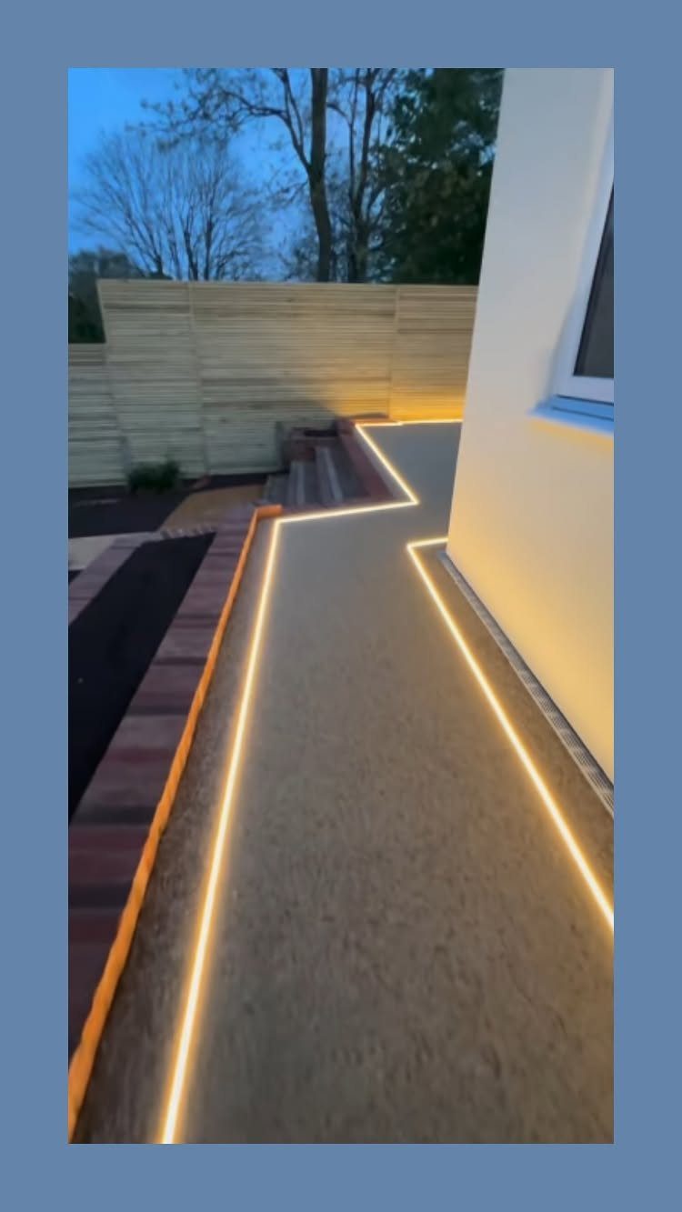 25 Patio Lights Ideas, From String Lights to Step Lighting 21 LED strip lighting illuminating the edges of a concrete patio and wooden stairs.