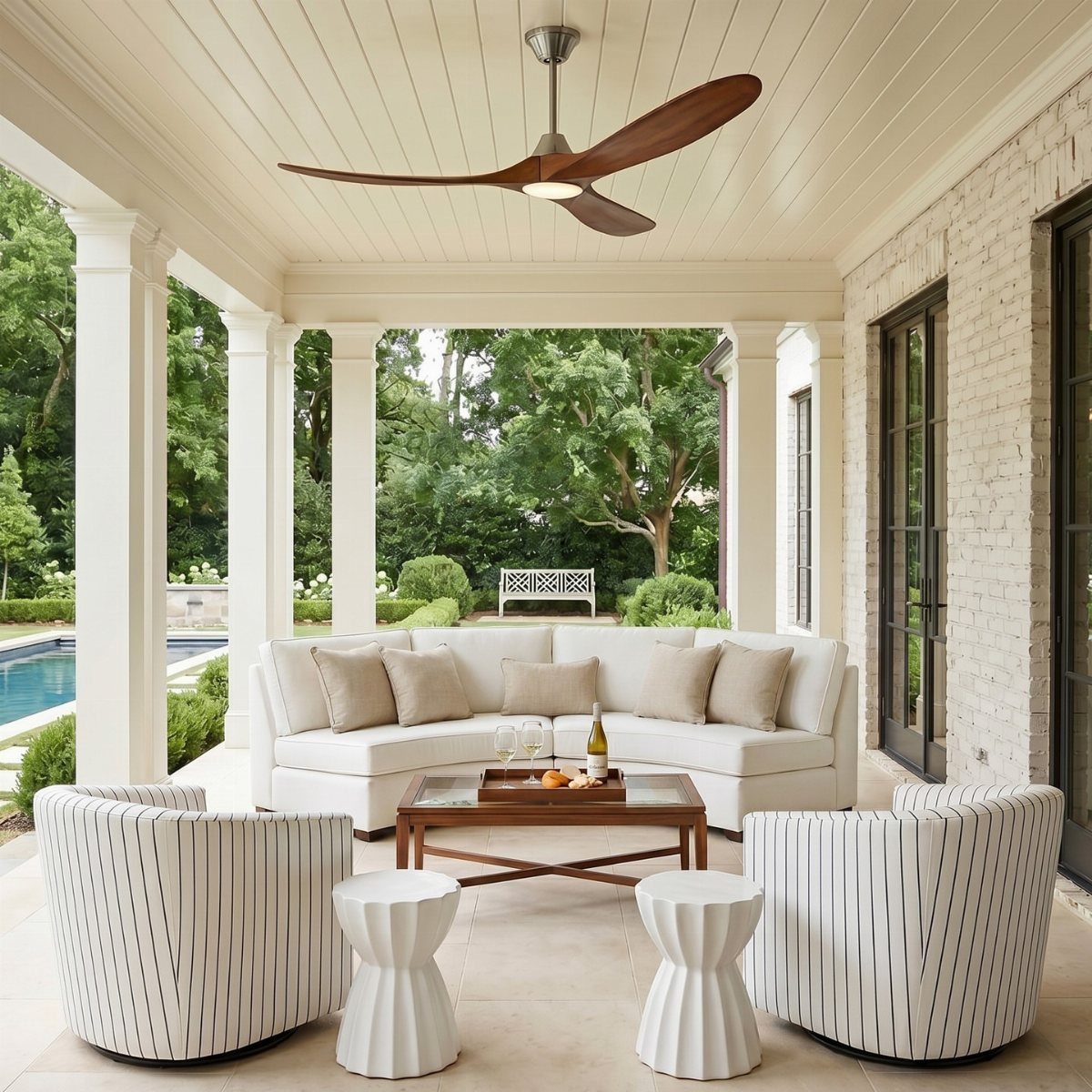 25 Patio Lights Ideas, From String Lights to Step Lighting 7 Covered outdoor patio with white furniture and a large brown ceiling fan.