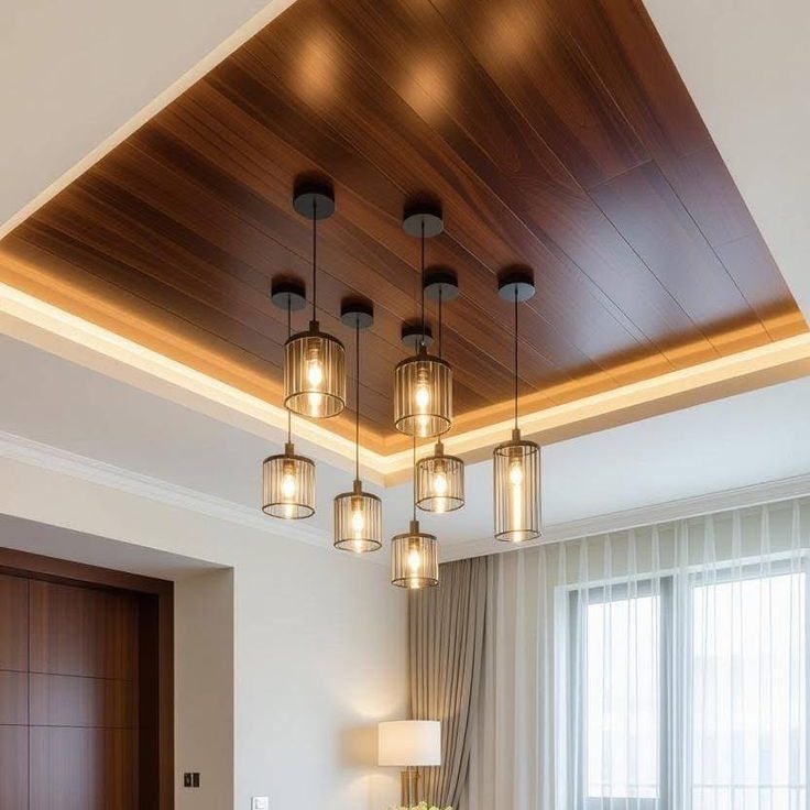 Dark wood-grain ceiling panels with hanging pendant lights and warm cove lighting in a modern room.