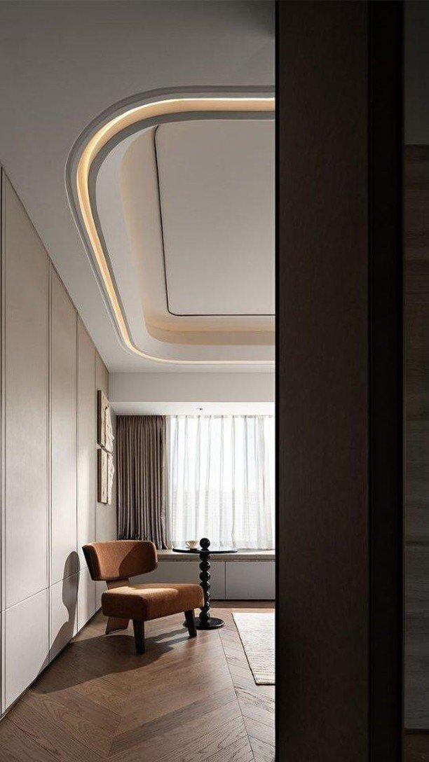 Curved POP ceiling design with warm cove lighting in a modern living room