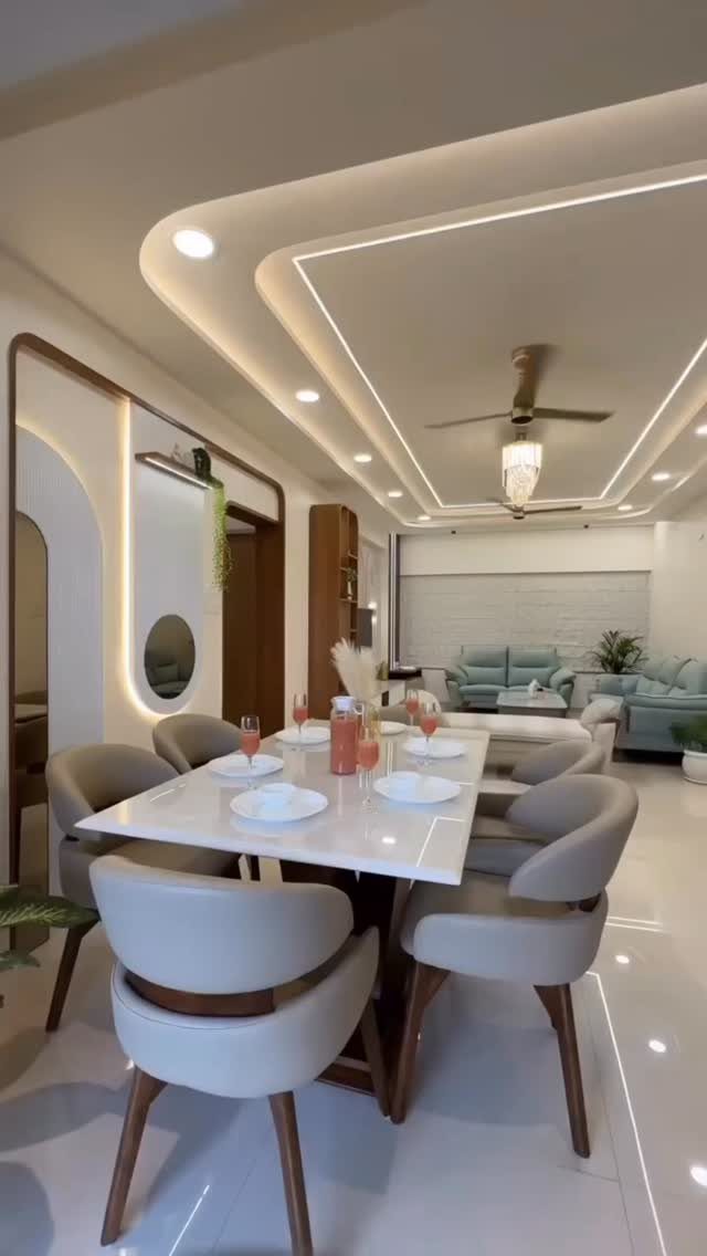 Layered white POP ceiling with recessed lighting over a modern dining room set