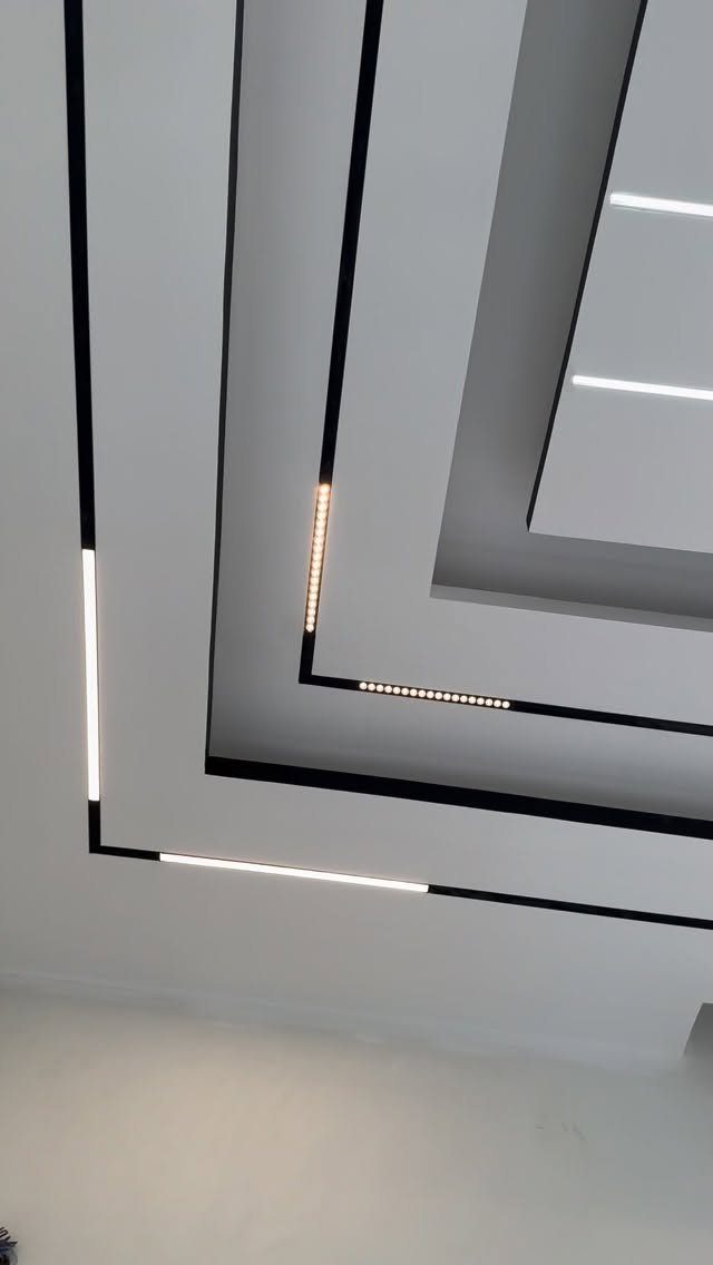 Modern white POP ceiling with recessed tiers, black accents and integrated LED lighting.