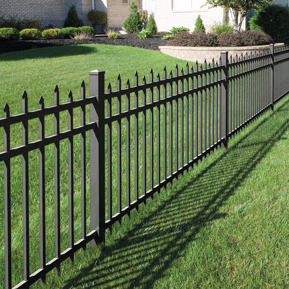 Black metal fence with pointed pickets bordering a green residential lawn.