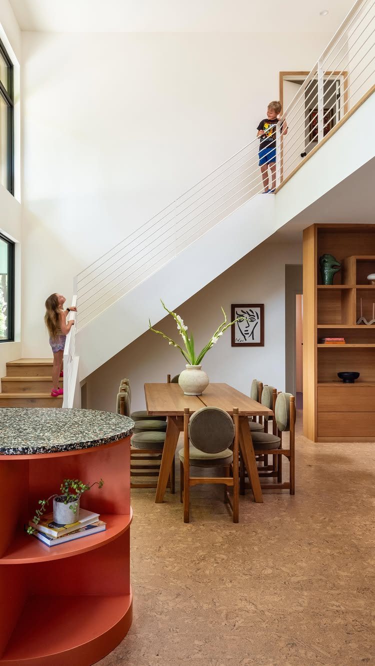 Types of Flooring: 10 Ideas from Hardwood to Rubber 6 Light brown cork flooring in a modern dining room with a wooden table and orange island.
