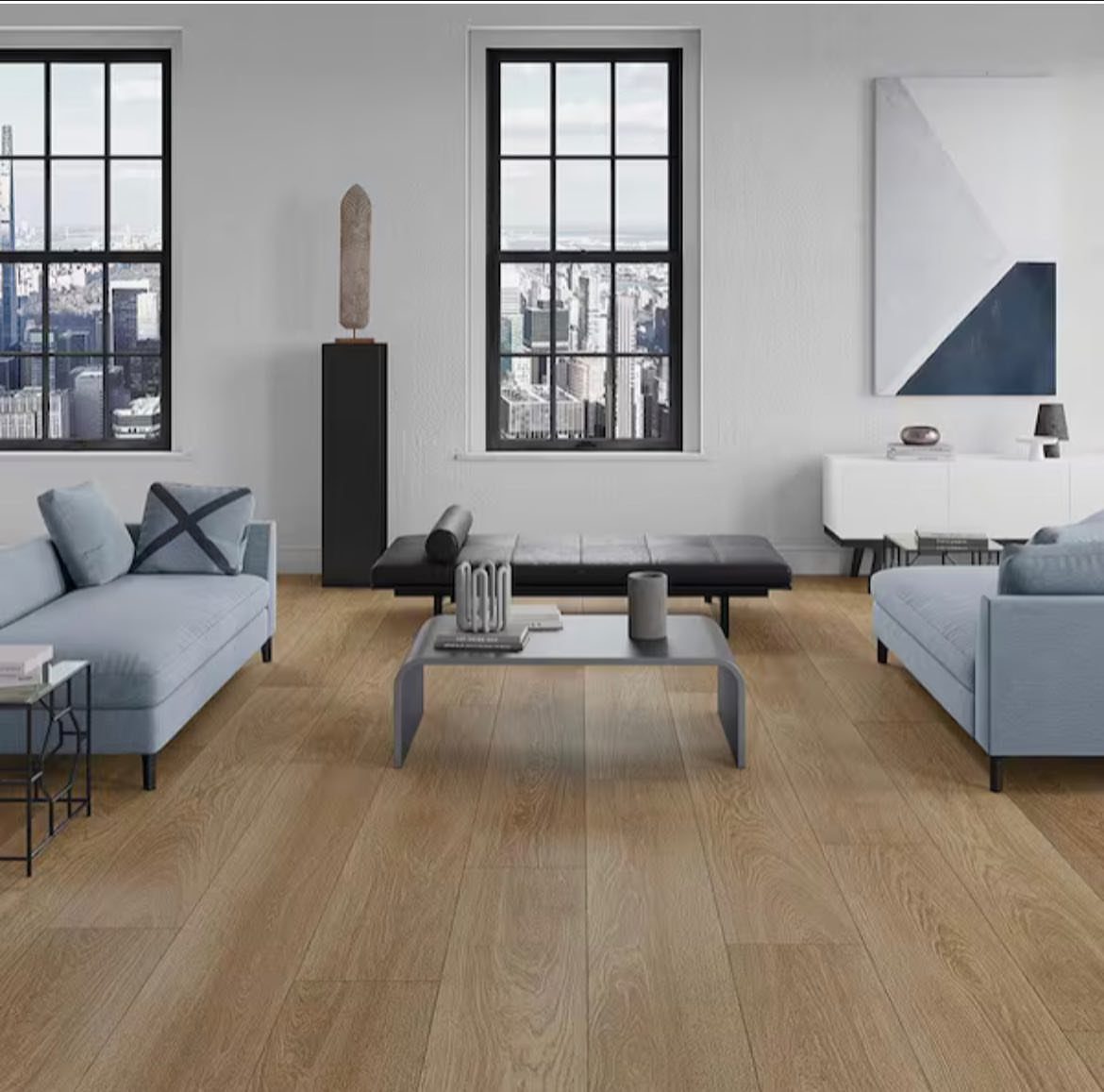 9 Vinyl Floor Colors for Every Room in 2026 8 Light wood plank flooring in a modern living room with blue sofas and city views.