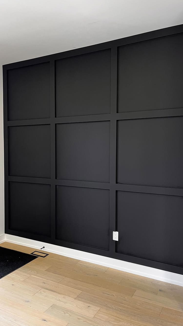 9 Wall Paneling Accent Wall Ideas for Every Room 9 Black grid-patterned wall paneling installed on an accent wall above light wood flooring.
