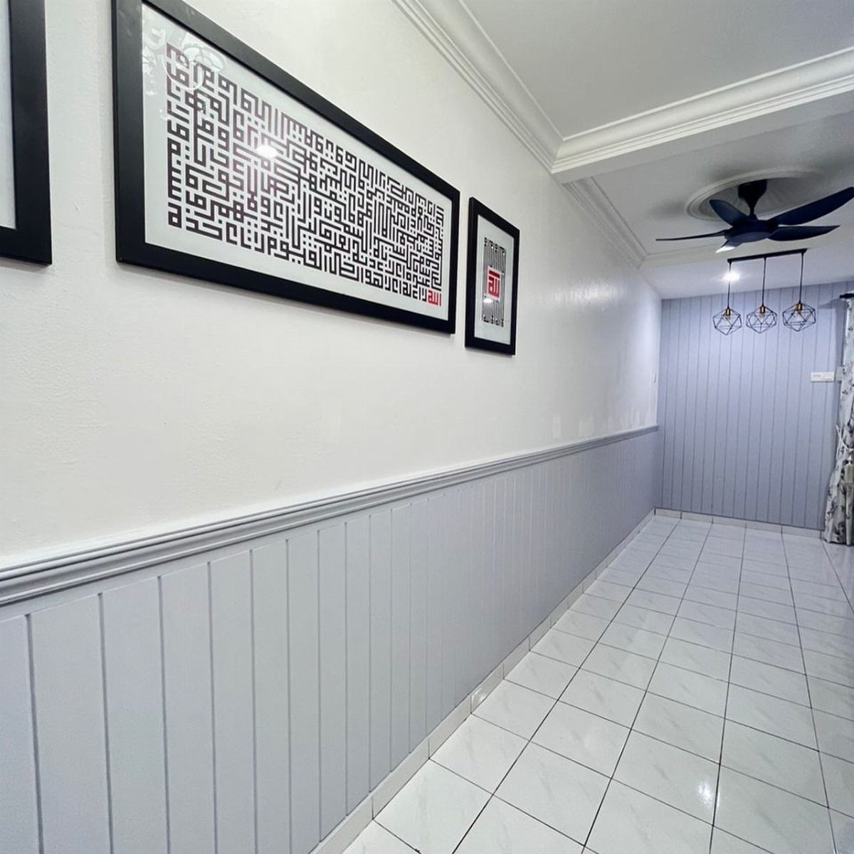 Light grey vertical beadboard wainscoting installed along the lower half of a white hallway wall.