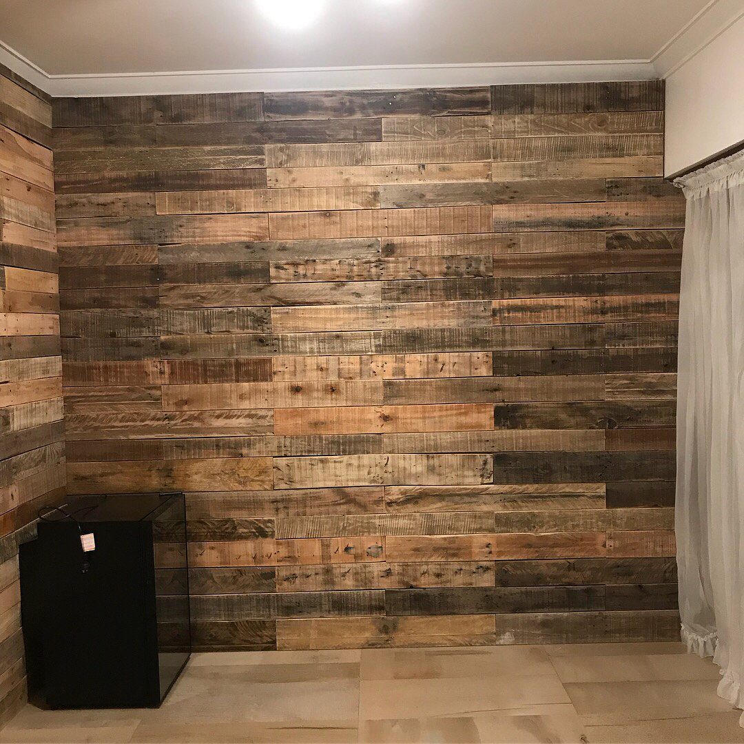 Rustic wooden planks in various brown tones covering a large interior accent wall.