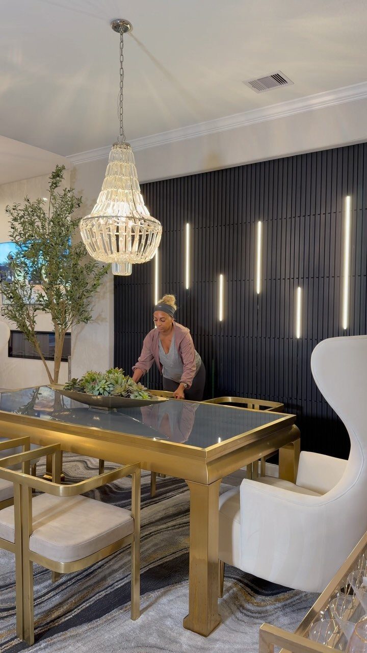 Dark vertical wood plank accent wall with integrated glowing LED light strips in a dining room.