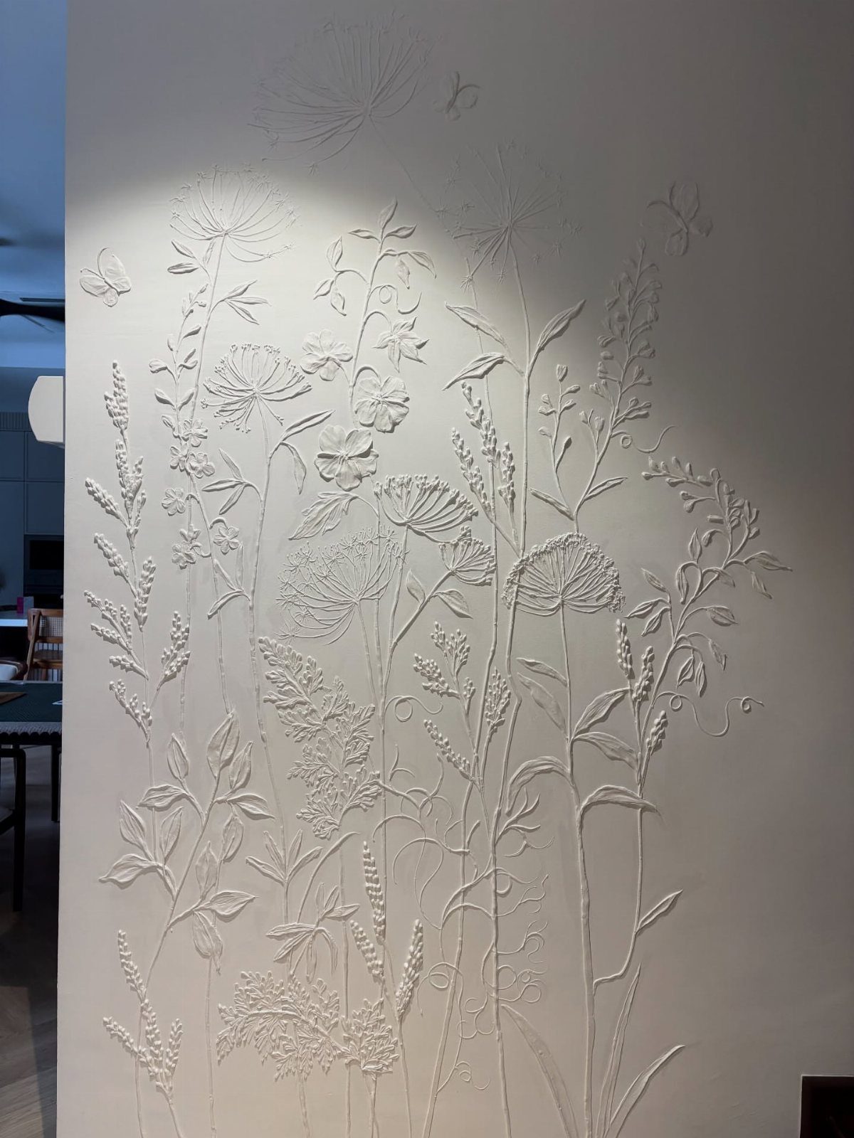 Wall Texture Design: 12 Ideas for Every Room 8 White wall with a raised three-dimensional floral and wildflower pattern texture.