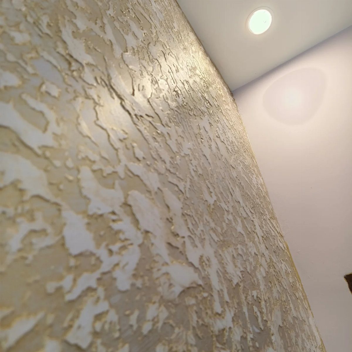 Wall Texture Design: 12 Ideas for Every Room 4 Rough beige stucco texture on a wall viewed from a low angle perspective.