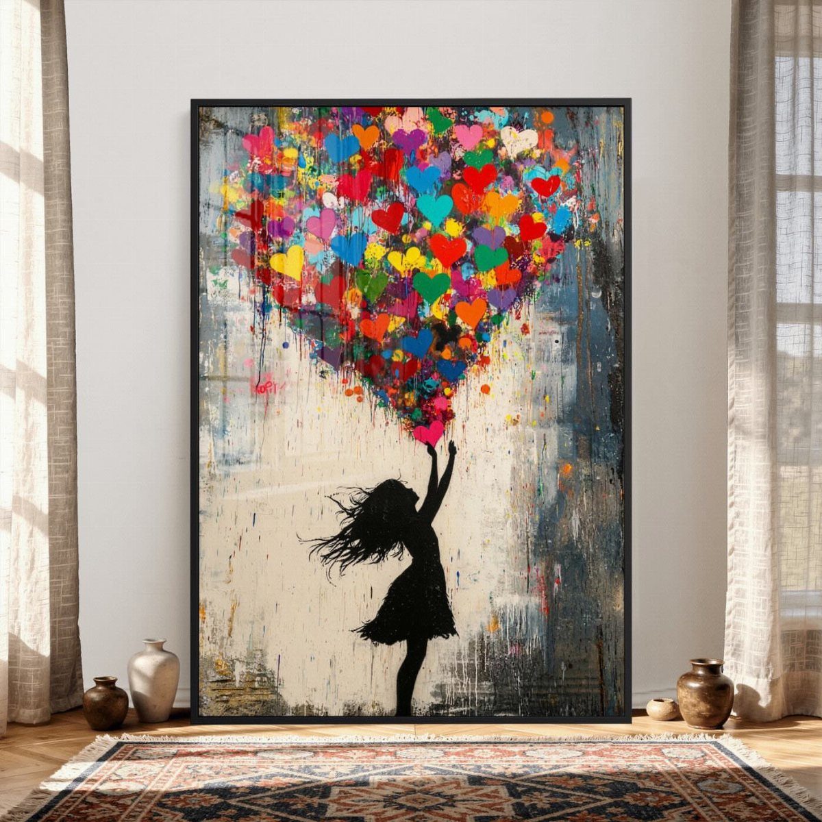 Colorful heart painting with a girl's silhouette leaning against a white bedroom wall.