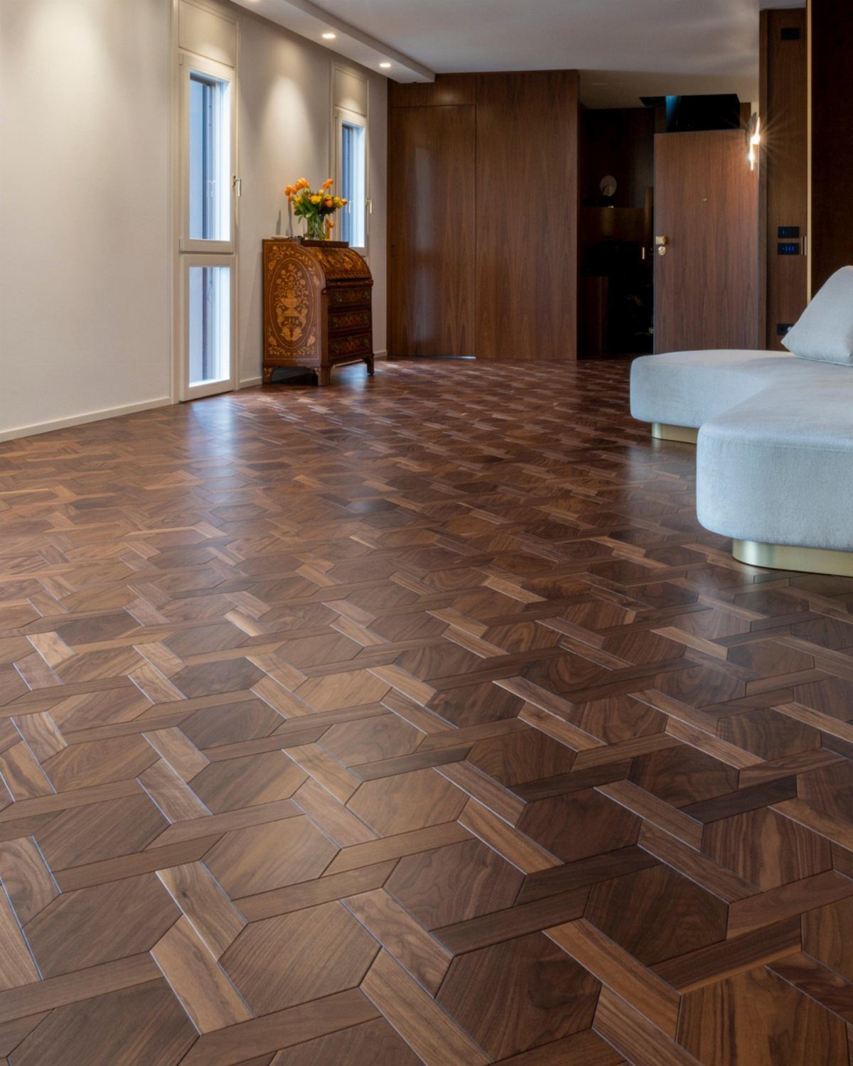 Dark wood parquet flooring with a complex geometric pattern in a modern living room.